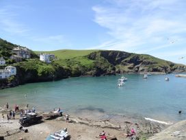 A beach scene with boats and people at The Old Vicarage St Issey