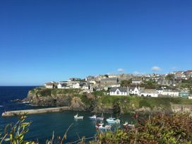 A seaside view with boats in a harbor at The Old Vicarage in St Issey