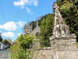 A church and stone wall along a road at The Old Vicarage in St Issey