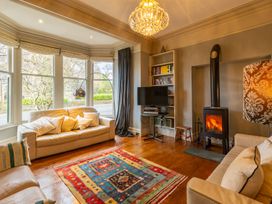 A living room with a sofa and fireplace at The Boundary in Windermere