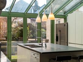 A kitchen with a sink and refrigerator at The Boundary in Windermere