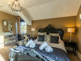 A bedroom with a bed and mirror at The Boundary in Windermere