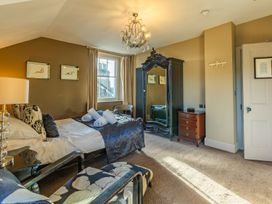 A bedroom with a bed and a mirror at The Boundary in Windermere