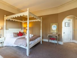 A bedroom with a four-poster bed and a desk at The Boundary in Windermere