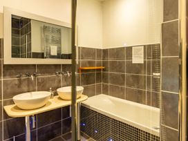 A bathroom with two wash basins and a bathtub at The Boundary in Windermere