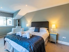 A bedroom with a bed and armchair at The Boundary in Windermere