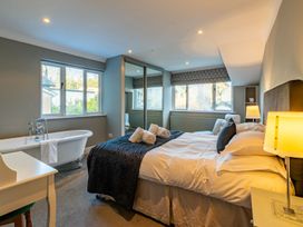 A bedroom with a bed and a bathtub at The Boundary in Windermere