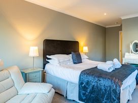 A bedroom with a bed and a sofa at The Boundary in Windermere