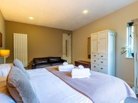 A bedroom with a bed and sofa at The Boundary in Windermere