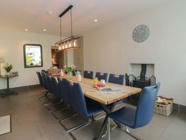 A dining room with a long table and chairs at The Boundary in Windermere