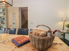 A dining room with a table set and a basket containing bread and eggs at The Boundary in Windermere