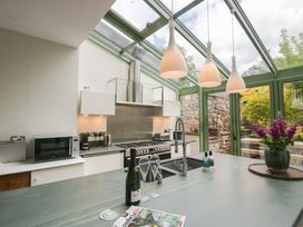 A kitchen with modern appliances and a view of outdoor greenery at The Boundary in Windermere