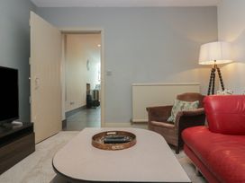 A living room with a sofa and TV at The Boundary in Windermere