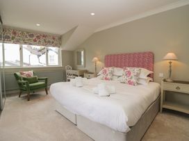 A bedroom with a bed and chair at The Boundary in Windermere