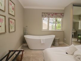 A bathroom with a bathtub and decorative wall art at The Boundary in Windermere
