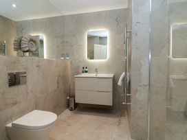 A bathroom with a shower, sink, and toilet at The Boundary in Windermere
