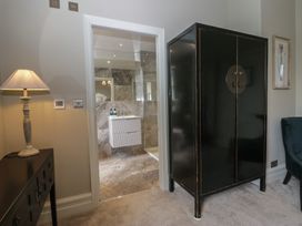 A bathroom with an open closet and a lamp at The Boundary in Windermere