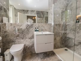 A bathroom featuring a toilet, sink, and shower at The Boundary in Windermere