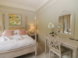 A bedroom with a bed, side table, and mirror at The Boundary in Windermere