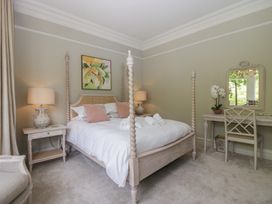 A bedroom with a bed, nightstand, and mirror at The Boundary in Windermere