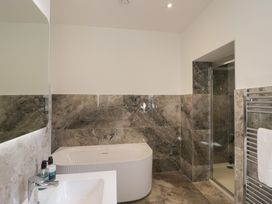 A bathroom with a shower, bathtub, and sink at The Boundary in Windermere