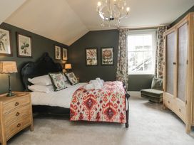 A bedroom with a bed, nightstand, and wardrobe at The Boundary in Windermere