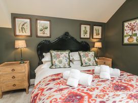 A bedroom with a bed, bedside tables, and artwork at The Boundary in Windermere