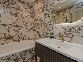 A bathroom with a bathtub and sink at The Boundary in Windermere