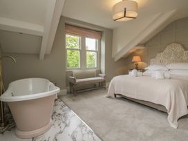 A bedroom with a bathtub and a bed at The Boundary in Windermere