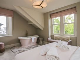 A bathroom with a bathtub and window at The Boundary in Windermere