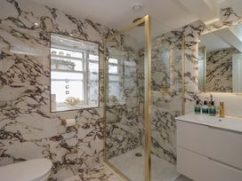 A bathroom with a shower, toilet, and sink at The Boundary Windermere