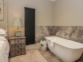 A bathroom with a freestanding bathtub and nightstand at The Boundary in Windermere