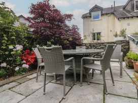 A garden with a table and chairs surrounded by plants at The Boundary in Windermere