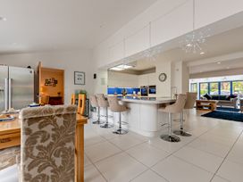 A kitchen with a dining area and bar stools at Sea Haze in Tenby