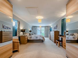 A bedroom with a bed and furniture at Sea Haze in Tenby
