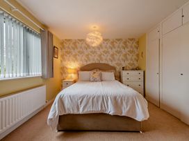 A bedroom with a bed and lamp at Sea Haze in Tenby