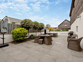 An outdoor garden with seating and a hot tub at Sea Haze in Tenby