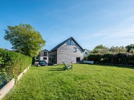 A house with lawn and trees at Sea Haze in Tenby