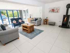 A living room with sofas and a fireplace at Sea Haze in Tenby