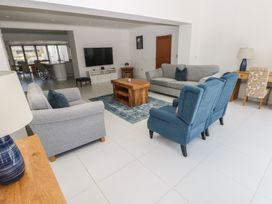 A living room with a sofa and coffee table at Sea Haze in Tenby