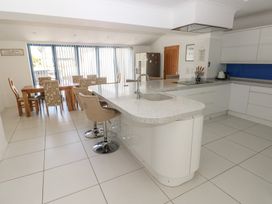 A kitchen with island and dining area at Sea Haze in Tenby