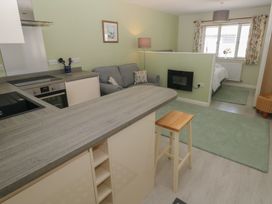 A kitchen with a bar counter and sofa at Sea Haze in Tenby