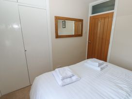 A bedroom with a bed and towels at Sea Haze in Tenby