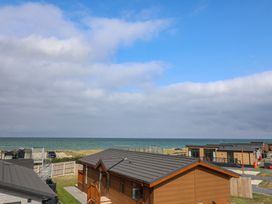 A view of cabins with ocean and sky at Lodge 1 in Norwich