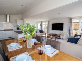 A dining area with a table set for meals at Lodge 1 Norwich