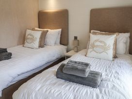 A bedroom with two beds and towels folded at Lodge 1 Norwich