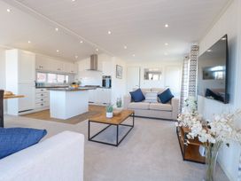 A living room with a sofa and coffee table at Sandy Snug in Bacton