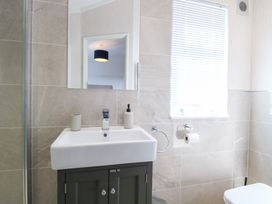 A bathroom with a sink and toilet at Sandy Snug in Bacton