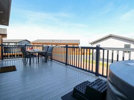 An outdoor area with a table and chairs at Sandy Snug in Bacton