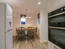 A dining room with a table and chairs at Tan Y Mynydd in Dwygyfylchi